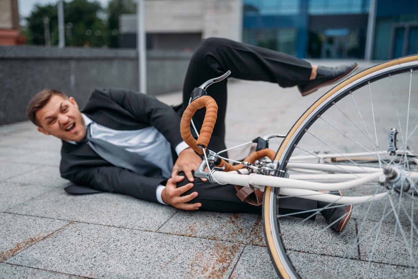 Businessman fell off his bike at office building